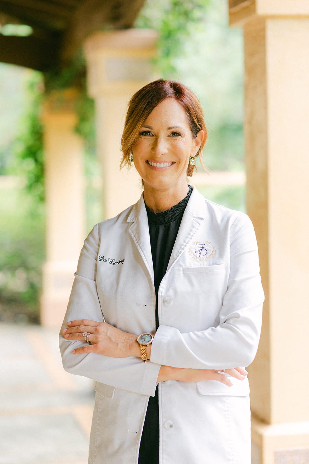 Dr. Jennifer Laskey, Dr. Jennifer Shiflet, and Dr. Zachary Viens wearing white lab coats over black dress clothes at Family Dentistry of Okeechobee in Okeechobee, FL